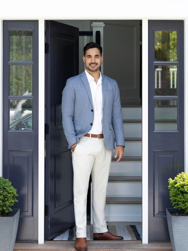 Gianluca, agente de bienes raíces que habla español, en la entrada de una casa en Long Island